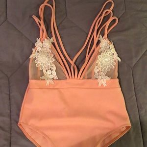 Peach body suit with mesh and cream appliqué